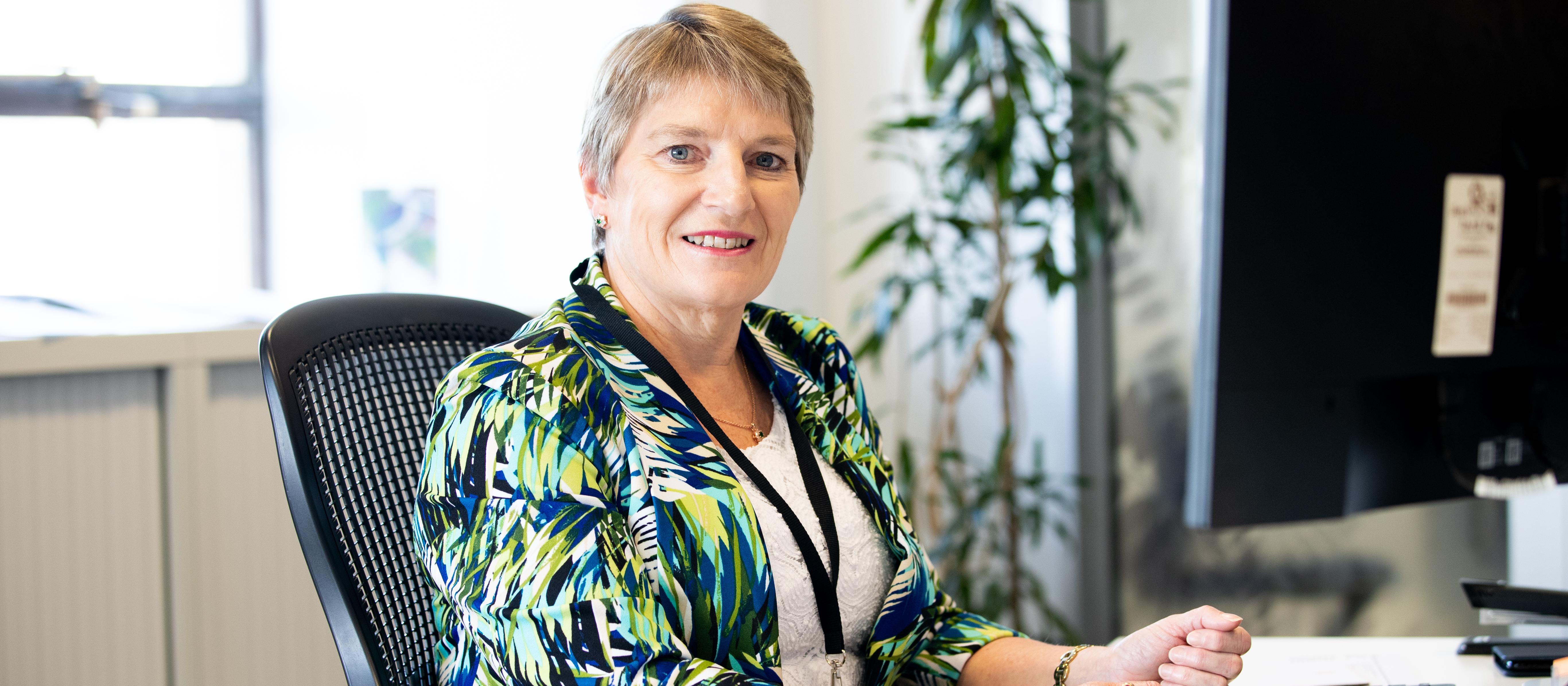 Lynne Hayman sitting at desk - RNZCGP high res 2020