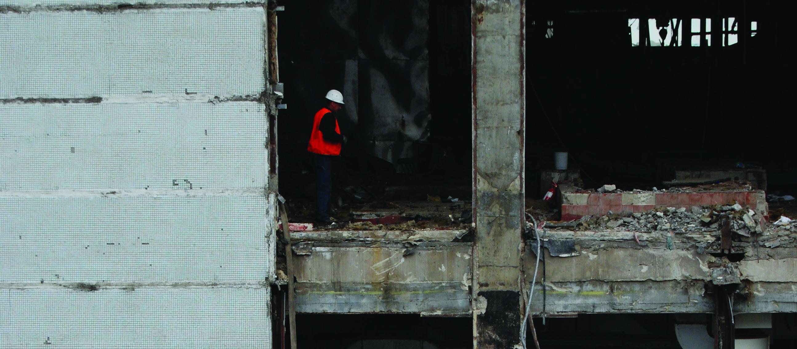 Building being demolished, demolition