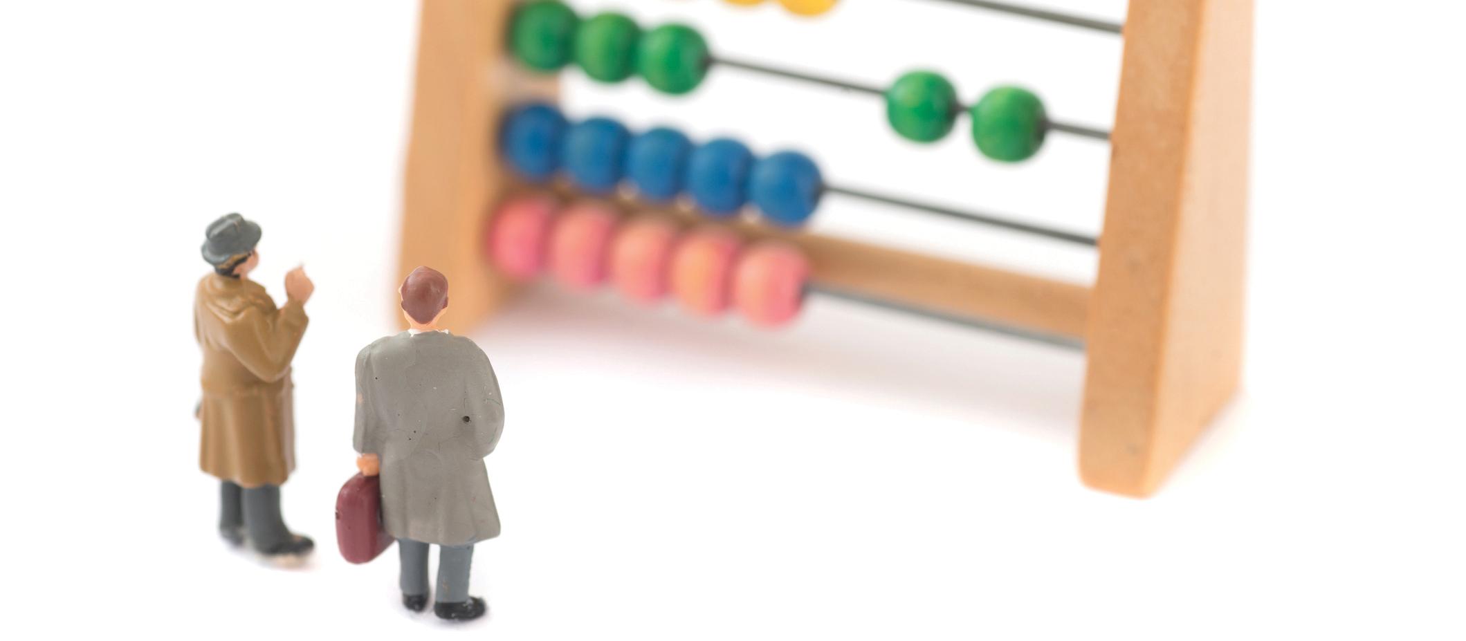 Miniature people with an abacus