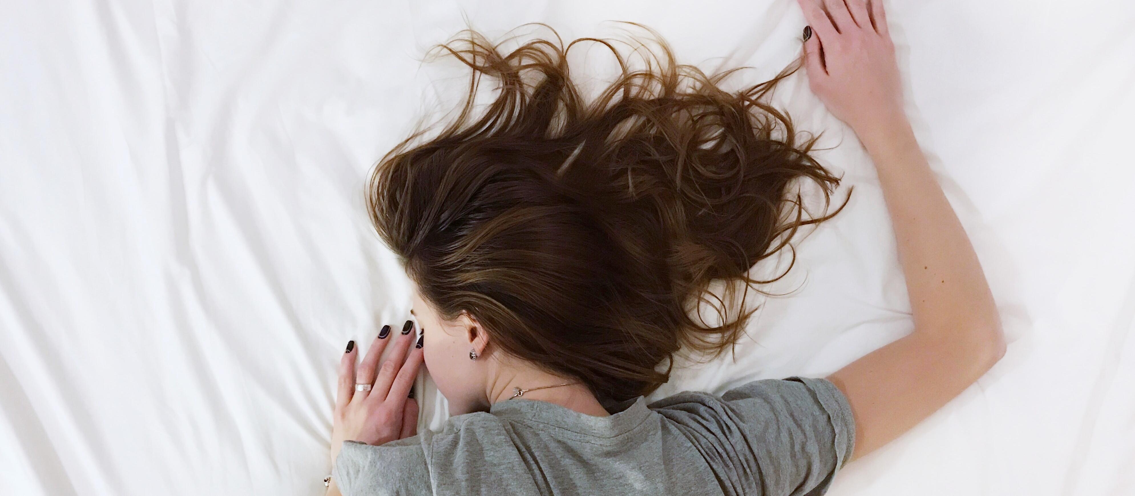 Woman lying on bed Photo by Vladislav Muslakov on Unsplash