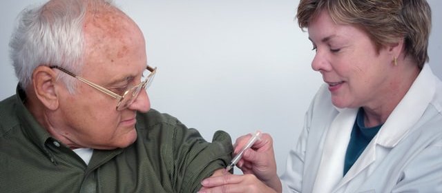 Older person being vaccinated [image: CDC on Unsplash]