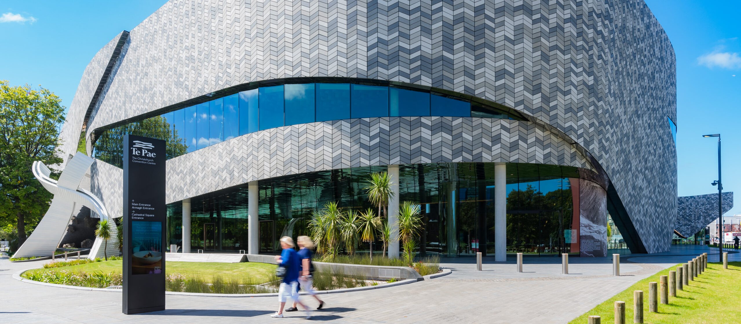 Image shows Te Pae convention centre from the outside, set against a blue sky