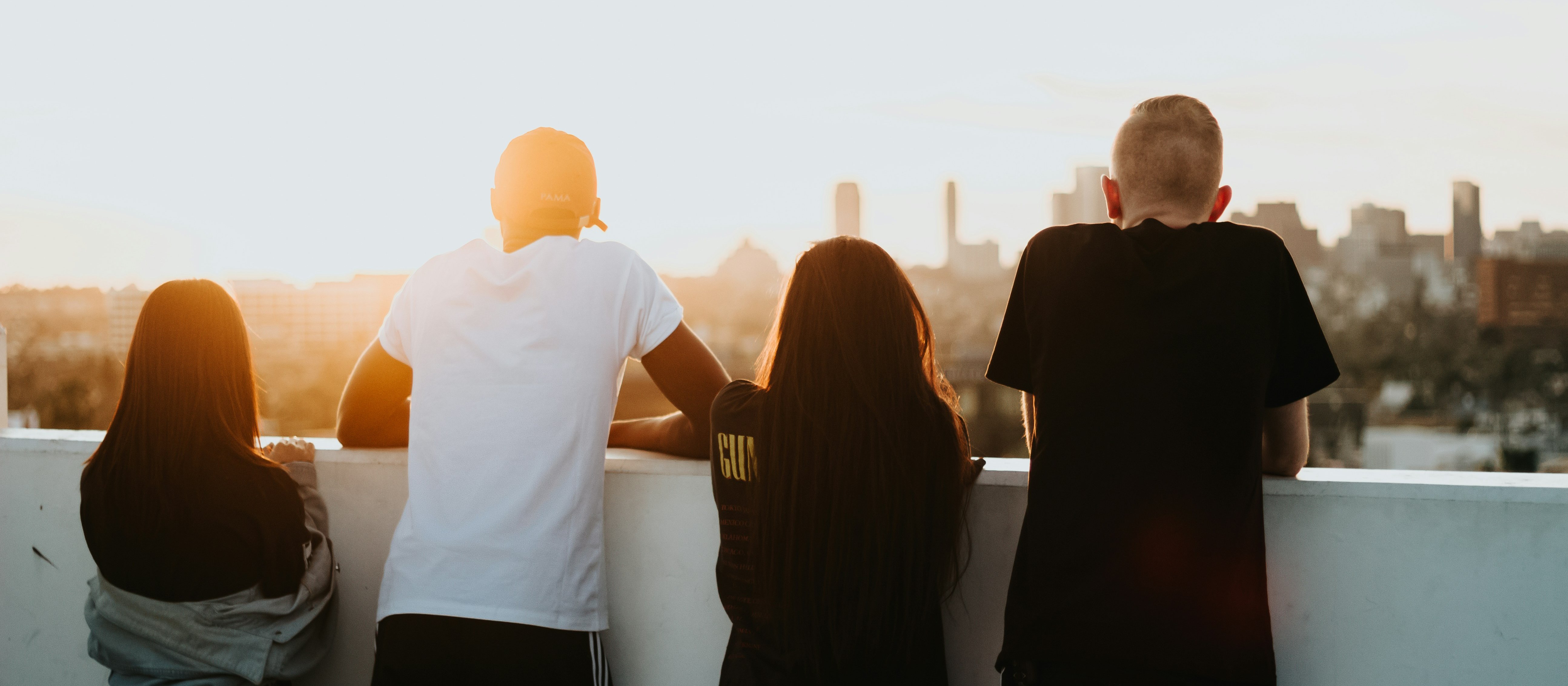 Young people overlooking city [Devin Avery on Unsplash]