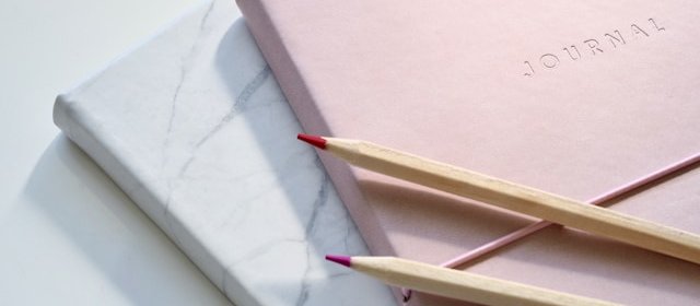 Journal and pencils CR Jess Bailey on Unsplash