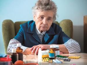 Elderly woman with pills