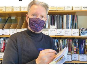 Alan with mask on and notebook