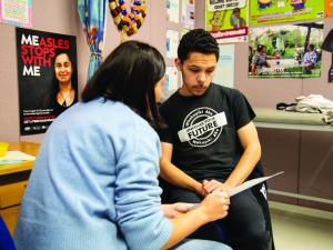 Nurse at Mangere College explaining the MMR vaccine