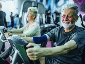 Older man exercising, exercise bike, elder health