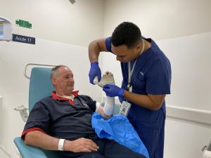 Matthew being treated by acute care nurse Henry Richardson