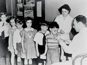 School children line for vaccination