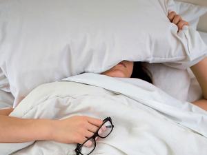 Woman in bed, stressed, 