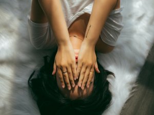 Woman covering face by Anthony Tran on Unsplash