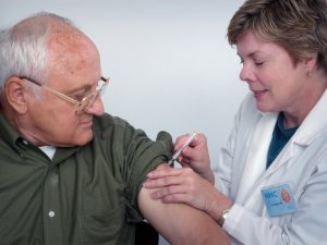 Older person being vaccinated [image: CDC on Unsplash]