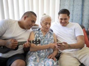 Elderly woman with whanau [Image: iStock]