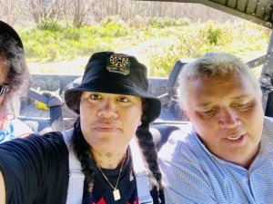 Colin Skudder (right) transports electrian Hone Welsh and kai coordinator Claudia Maaka between Tokomaru Bay and Te Puia Hospital in his side-by-side - the only way in [Image: supplied]