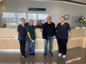 Image shows staff from Counties Medical Takanini standing in front of the reception desk