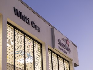 Image shows corner of building in dawn light, signage reads Whiti Ora, Starship Foundation