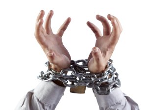 Hands in chains [AdobeStock]