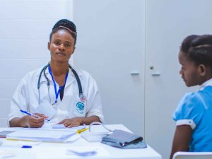 Black female doctor with patient