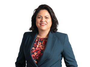 Ayesha Verrall, dressed in navy blue suit and floral top