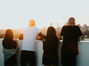 Young people overlooking city [Devin Avery on Unsplash]