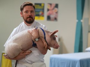 Thaddeus Fleiss (Paul Waggott) holding Alexander the pig [Image: Supplied]