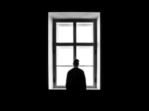 Man at window, shadows [Photo by Sasha Freemind on Unsplash]