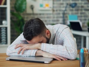 Man resting on laptop CR Vitaly Gariev on Unsplash