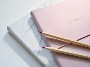 Journal and pencils CR Jess Bailey on Unsplash