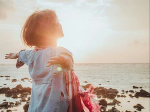 Woman, arms spread, sunshine